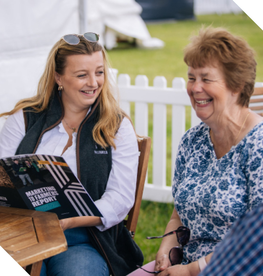 Two visitors reading the report at an agricultural show