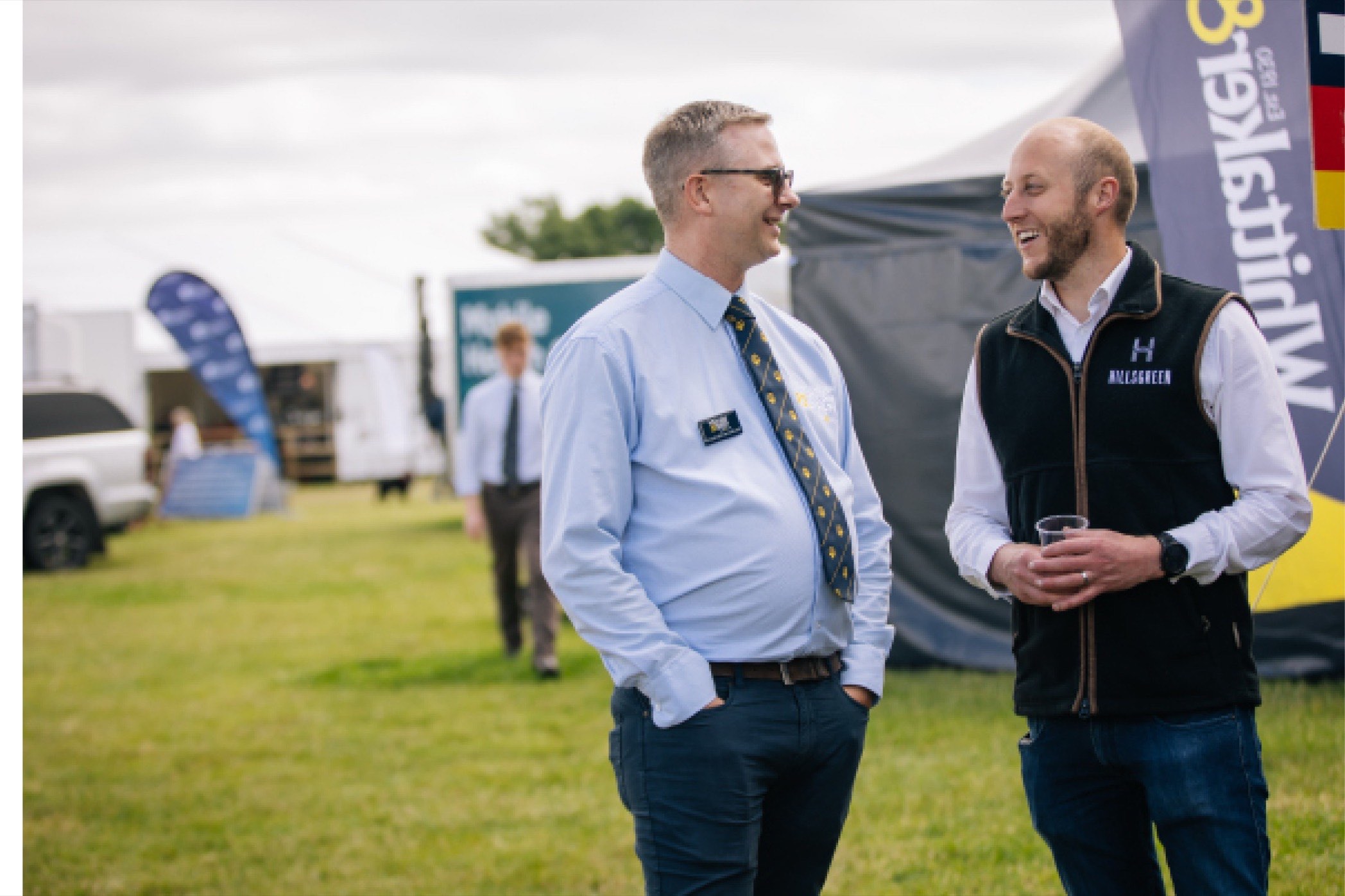 Two Hillsgreen colleagues talking at an agricultural show